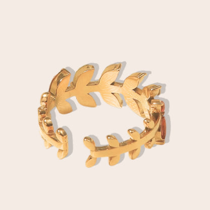 Bali Botanical Eternity Band. This eye-catching, adjustable ring features a captivating leaf-shaped design adorned with multi-colored AAA zirconia stones, all set on stainless steel with IP gold plating.