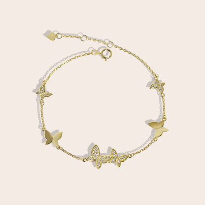 Beret Butterfly Bracelet in gold, a charming piece crafted from sterling silver and adorned with sparkling crystals.