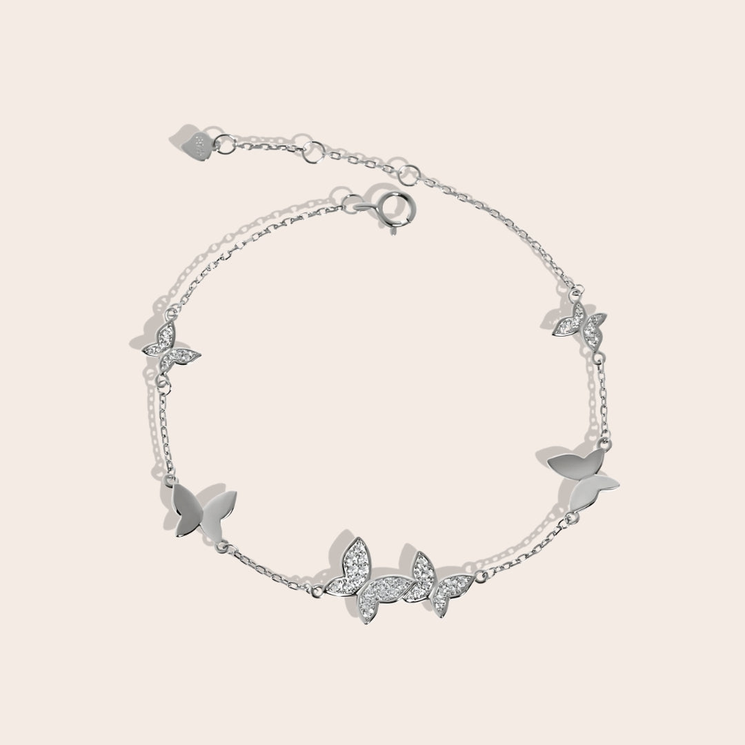 Beret Butterfly Bracelet in silver, a charming piece crafted from sterling silver and adorned with sparkling crystals.