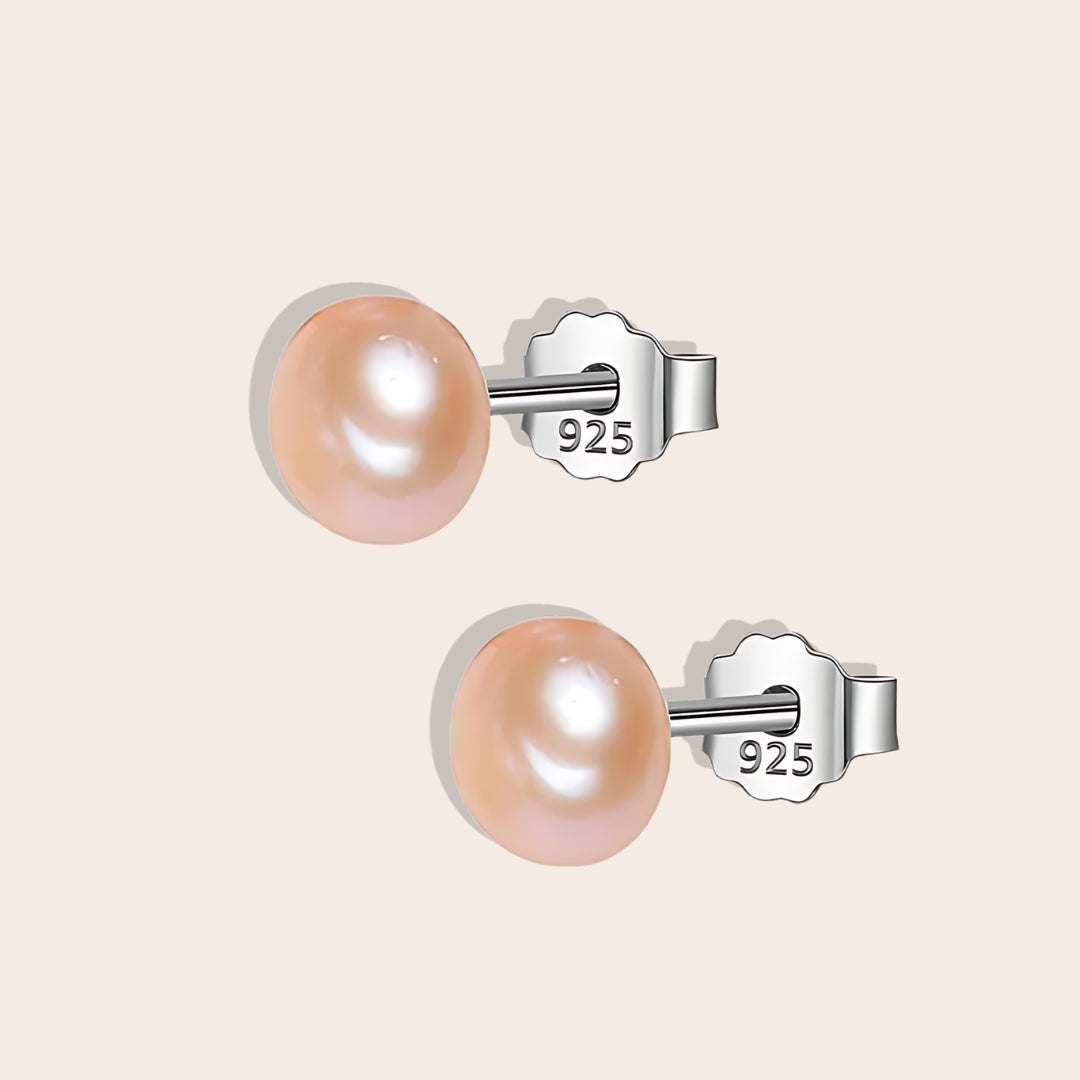 Bianca Baroque Pearl Studs in rose. These stunning earrings feature unique freshwater pearls nestled in 925 sterling silver settings and plated with 18K gold.