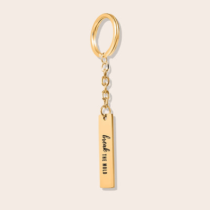 Vertical Bar Keychain - Break the Mold. Made from durable stainless steel and luxuriously plated in 18K gold with a positive affirmation.