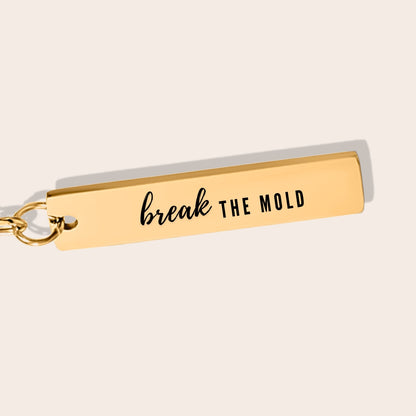 Vertical Bar Keychain - Break the Mold close up. Made from durable stainless steel and luxuriously plated in 18K gold with a positive affirmation.