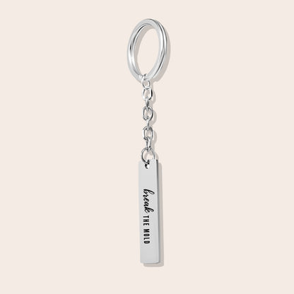 Vertical Bar Keychain - Break the Mold. Made from durable stainless steel and luxuriously plated in silver steel with a positive affirmation.