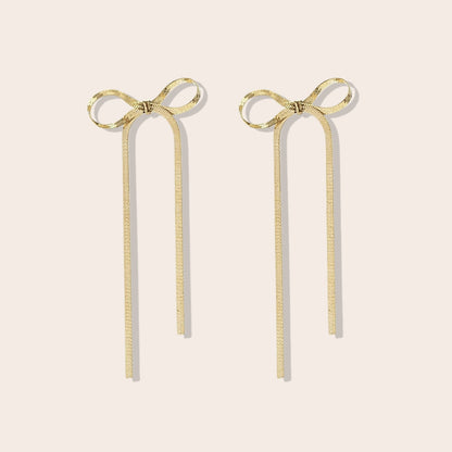 Coquette Bow Drop Earrings in gold. Constructed from lasting stainless steel.