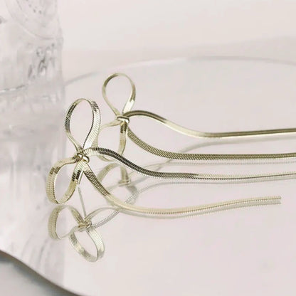 Coquette Bow Drop Earrings in gold. Constructed from lasting stainless steel.