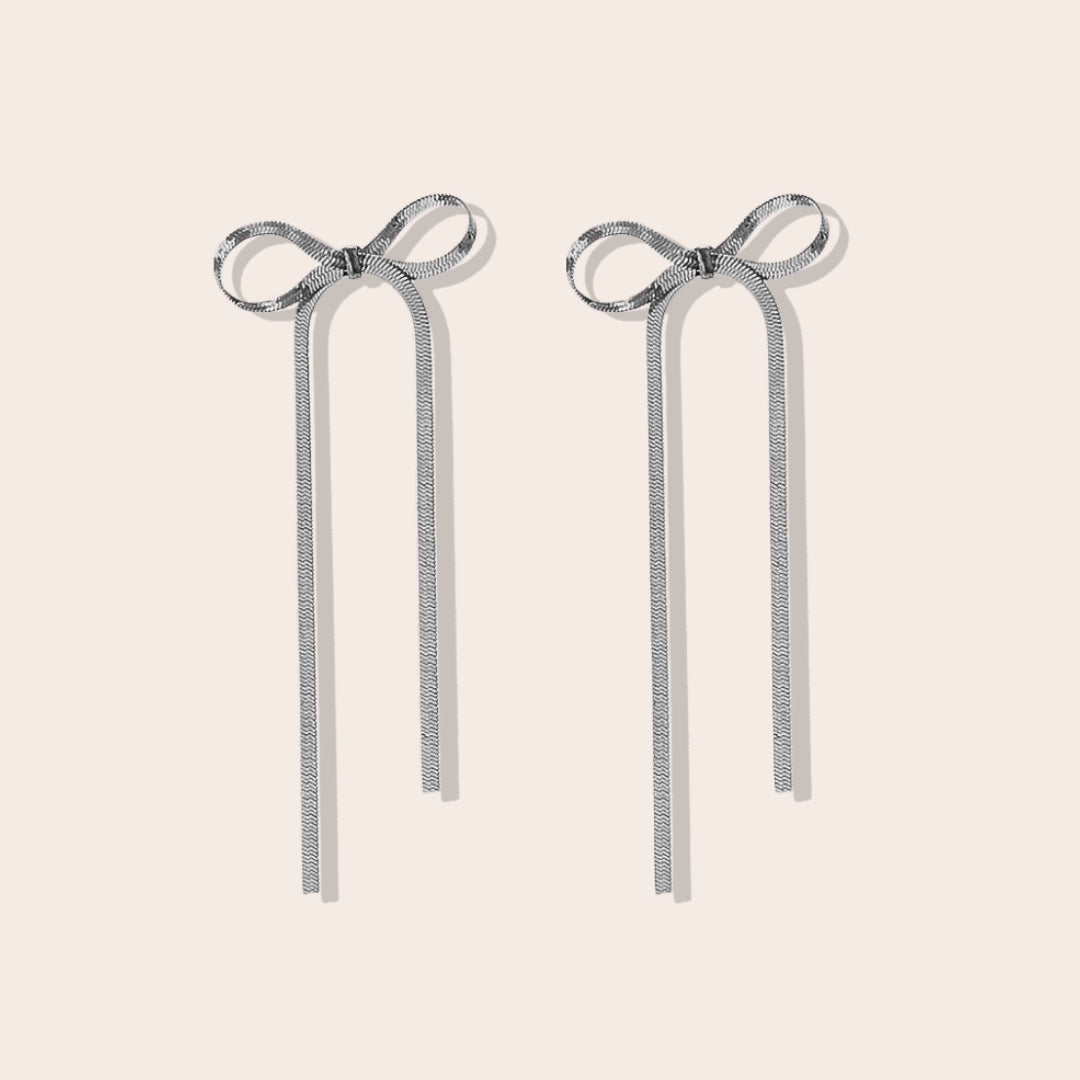 Coquette Bow Drop Earrings in silver. Constructed from lasting stainless steel.