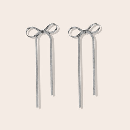 Coquette Bow Drop Earrings in silver. Constructed from lasting stainless steel.