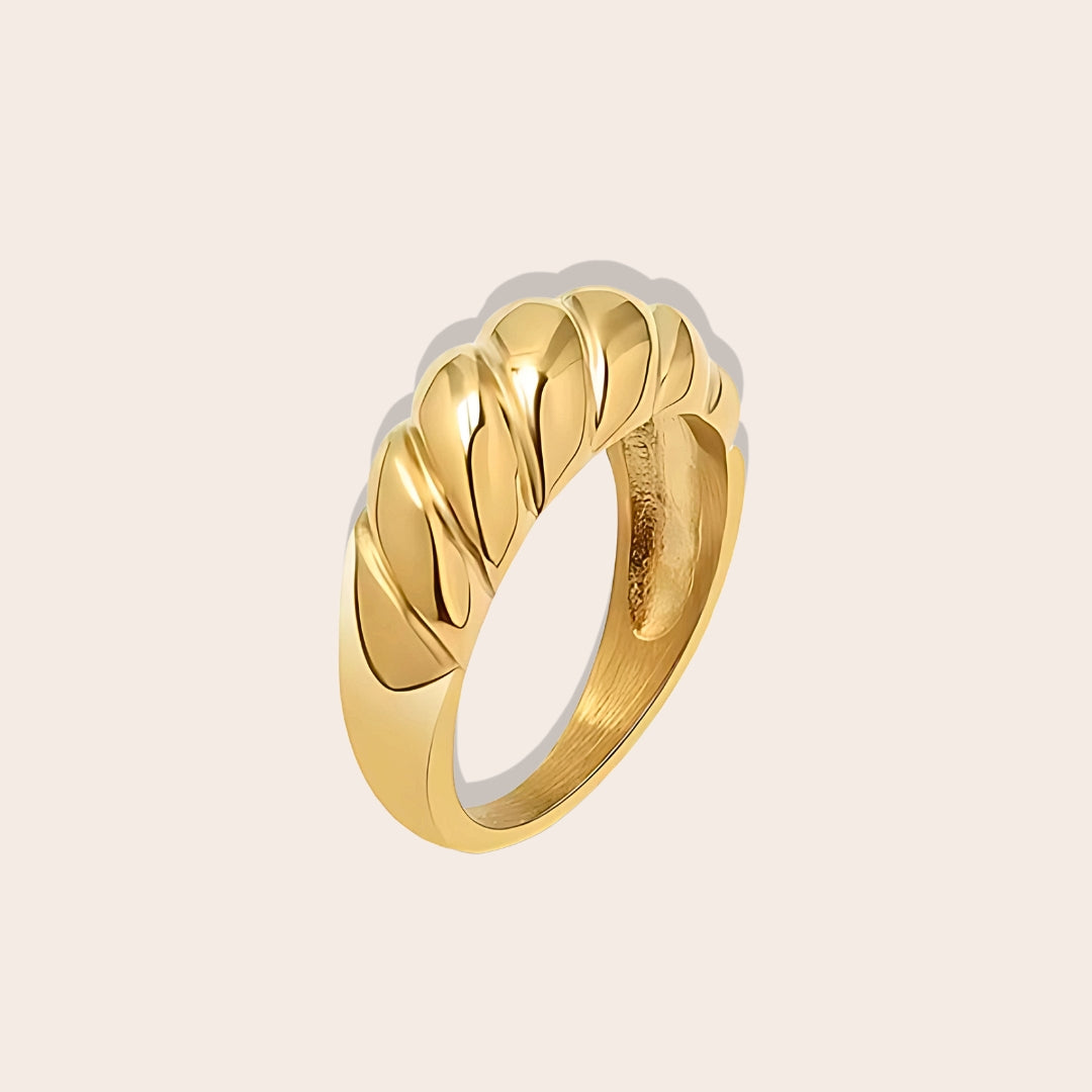 Crafted from durable stainless steel and luxuriously plated with 18K gold, this chunky ring features a unique twist design.