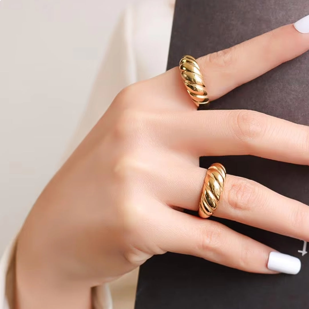 Crafted from durable stainless steel and luxuriously plated with 18K gold, this chunky ring features a unique twist design on model.