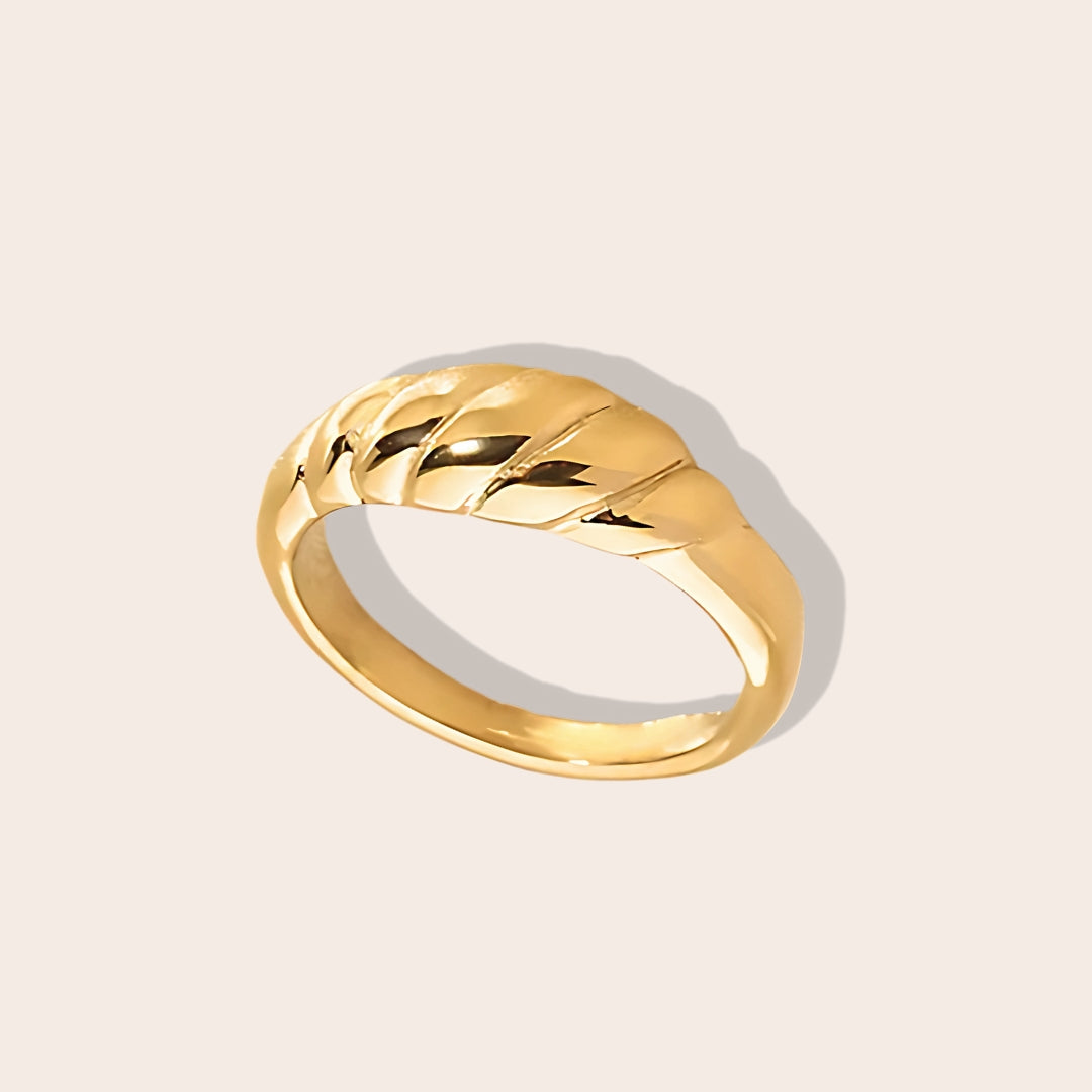 Crafted from durable stainless steel and luxuriously plated with 18K gold, this chunky ring features a unique twist design. Petite version.