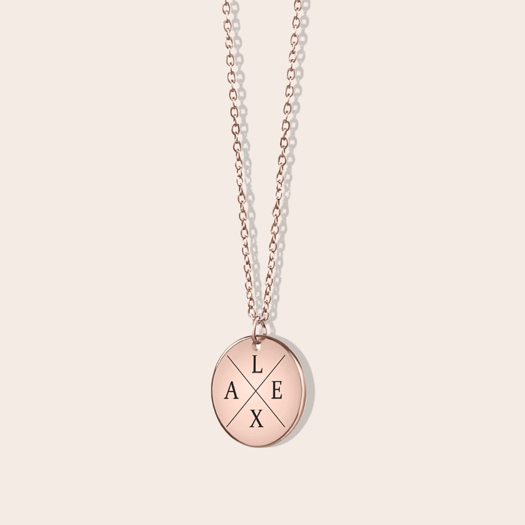 Personalized initials necklace studio shot. Rose gold coin shape with rose gold chain.