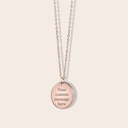 Personalized initials necklace studio shot. Rose gold coin shape with rose gold chain. Back side with custom message engraving.