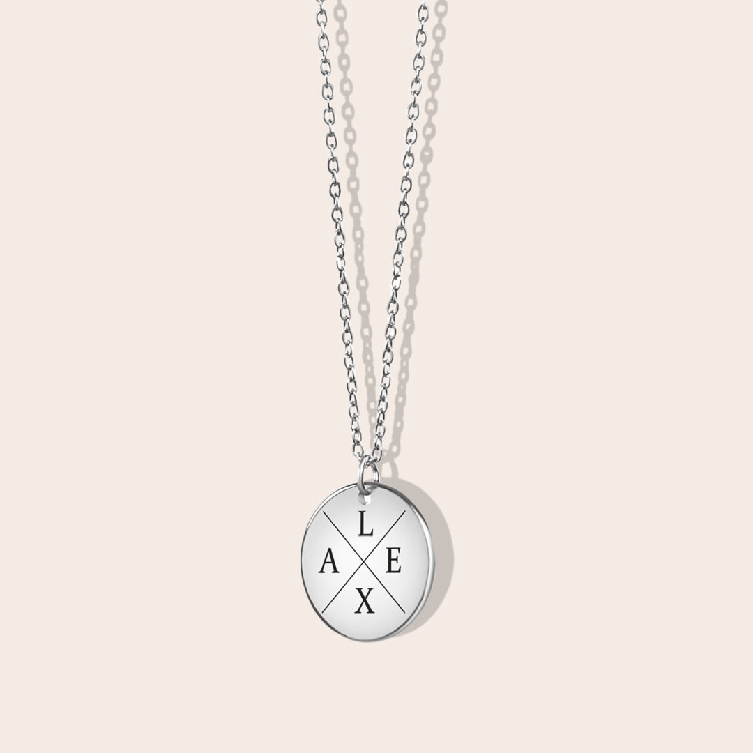 Personalized initials necklace studio shot. Silver coin shape with silver chain.