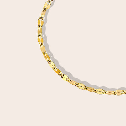 Close up of Danae Dapped Chain Anklet in gold. Crafted from stainless steel and plated in 14k gold.