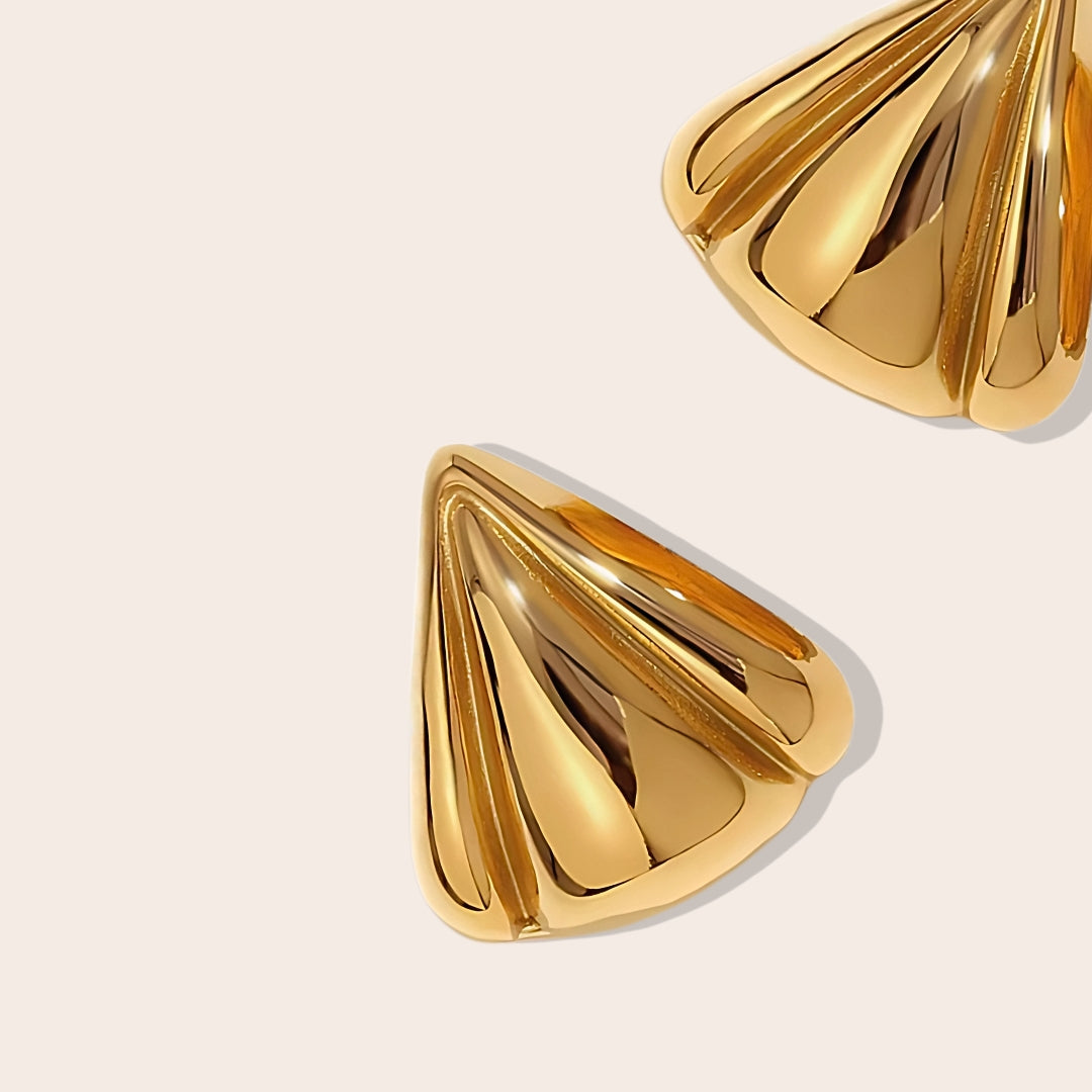 Close up of Dallas Delta Earrings. Made of stainless steel and lavishly coated in 18K PVD gold plating.