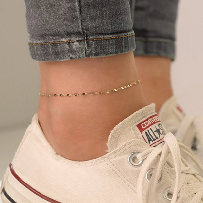 Danae Dapped Chain Anklet on model. Crafted from stainless steel and plated in 14k gold.