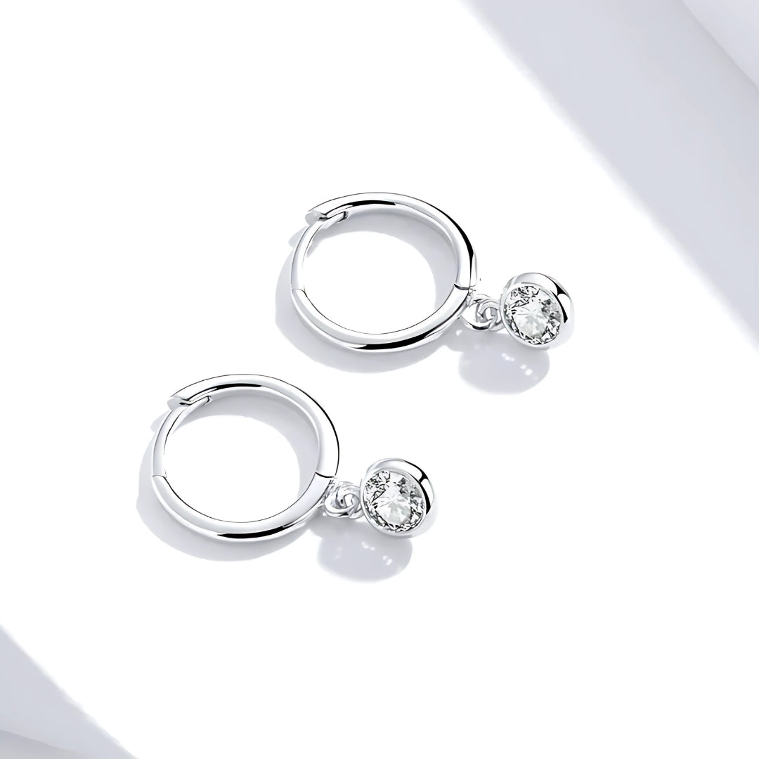 Lifestyle shot of Dara Drop Huggies, featuring premium 925 sterling silver and pavé set cubic zirconia stones.