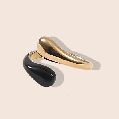 Enid Enamel Wrap Ring in black. This eye-catching piece features an open, spiral design that gracefully wraps around your finger, combining the durability of stainless steel with the vibrant allure of enamel.