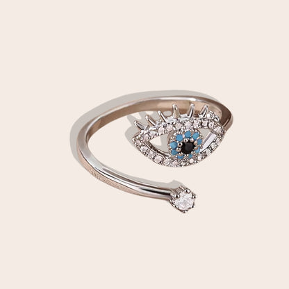 Esme Evil Eye Ring. The ring is constructed from stainless steel, adorned with naturally occurring zircon stones, and designed to fit any finger with its open adjustable band. 