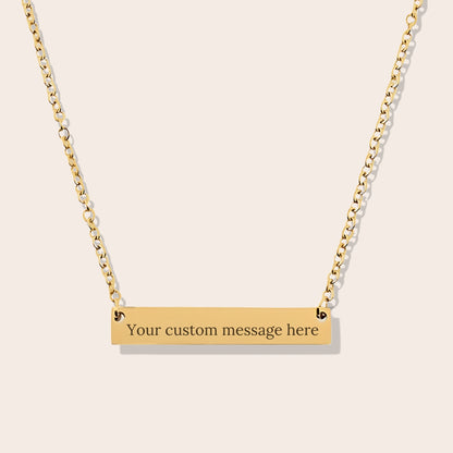 Back side of Customizable couples name necklace with front engraving and special message for back engraving. Gold, horizontal bar orientation.