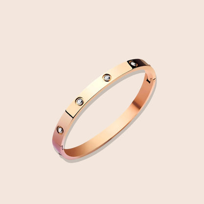 Harlow Hinged Bangle in rose gold, a dazzling fusion of sleek stainless steel and twinkling zircon stones.