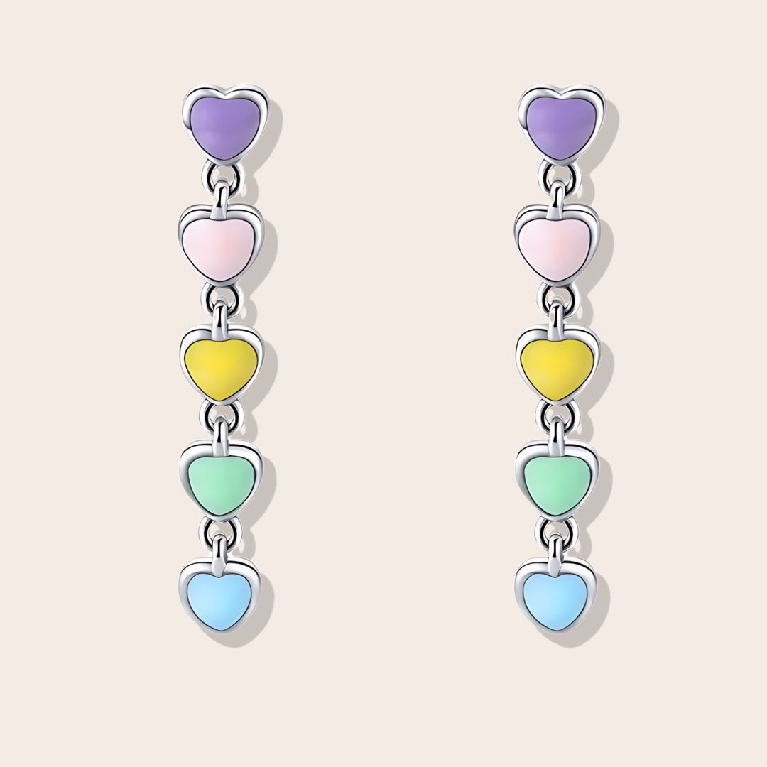 Heart-to-Heart Huggies. Crafted from premium 925 sterling silver, these earrings feature a heart-to-heart design, beautifully accented with splashes of color.