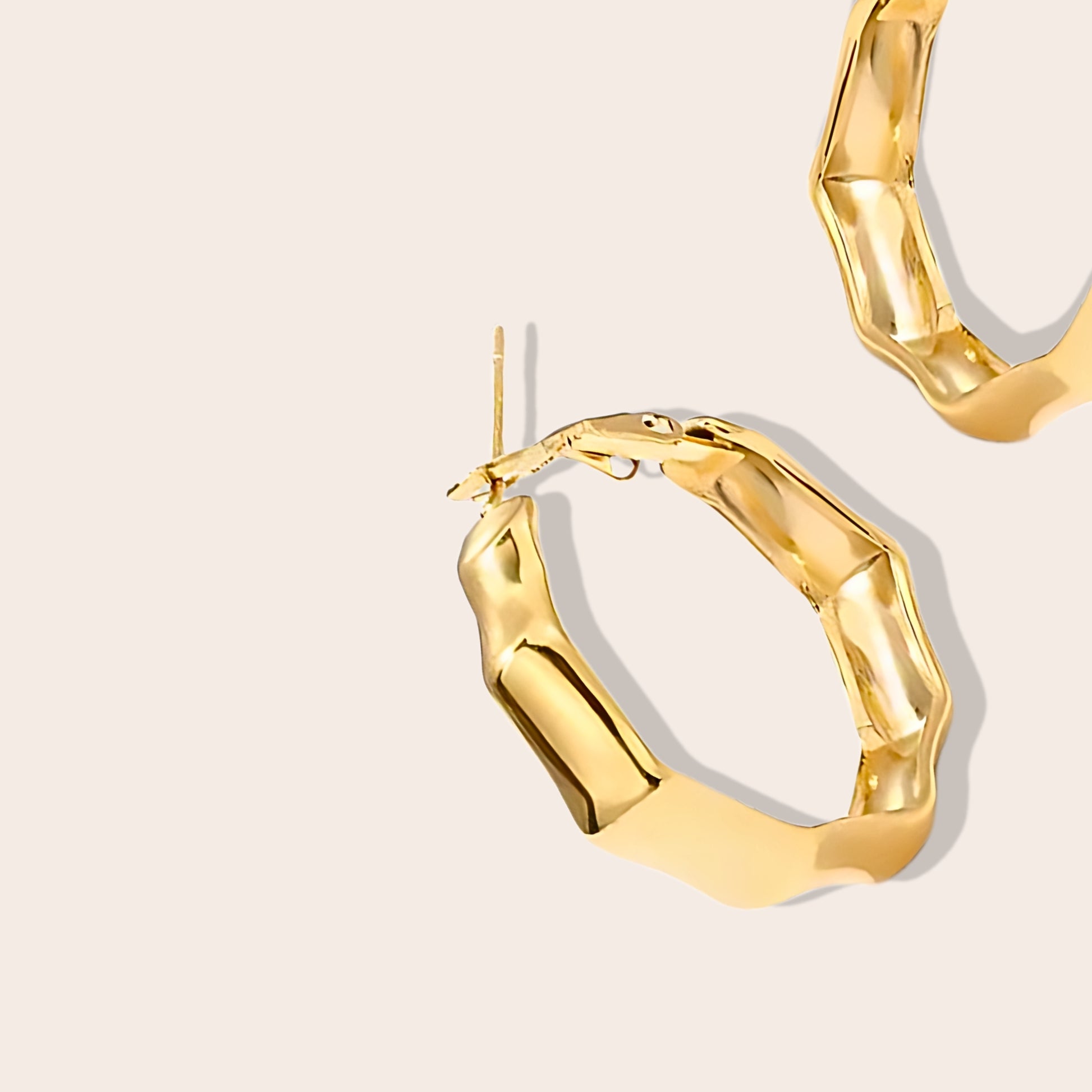 Close up of Hollis Heptagon Hoops in gold, crafted from sleek stainless steel silver.