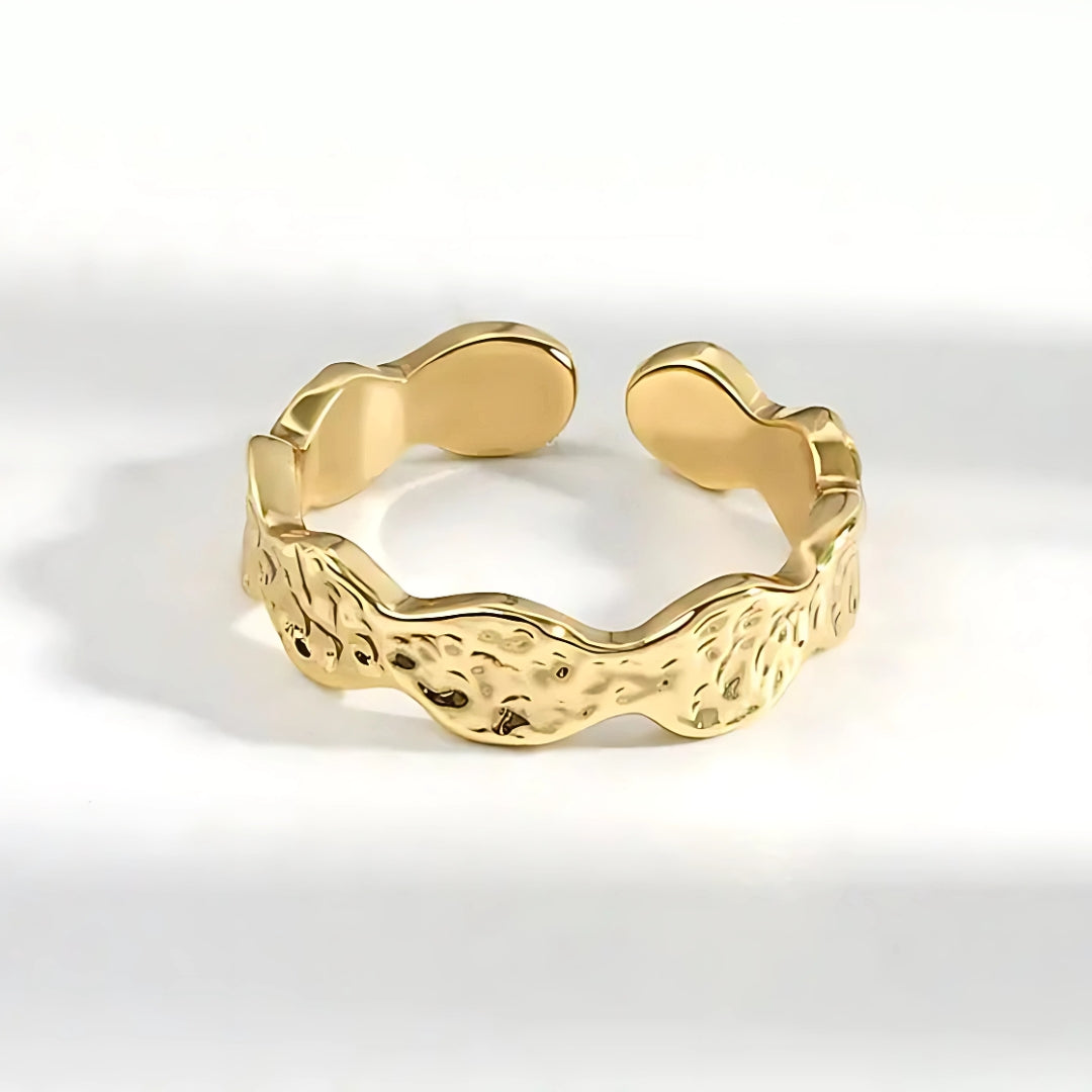 Hutton Hammered Ring in gold, made of stainless steel, features a unique scalloped design with a hammered texture. Lifestyle shot.