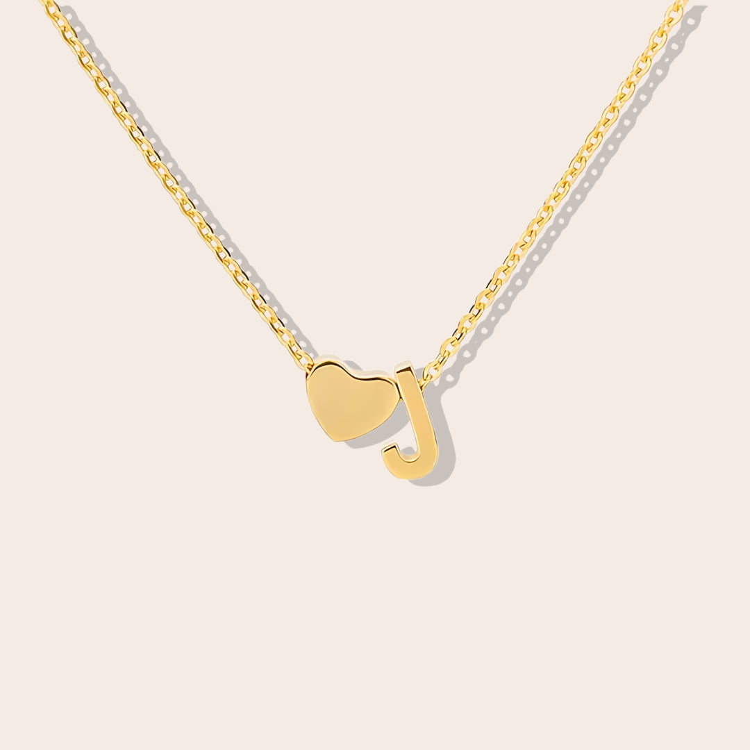 Inez Initial Heart Pendant. Crafted from stainless steel and finished in a luxurious gold hue.