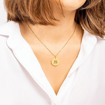 Initials Coin Necklace in gold on a model. Laser engraving available on back side. 