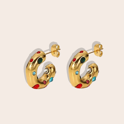 Iris Irregular Studded Huggies. Crafted from 18K gold plated stainless steel, feature an irregular, chunky shape with an enchanting array of zircon stones.