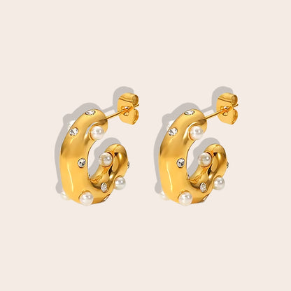 Iris Irregular Studded Huggies. Crafted from 18K gold plated stainless steel, feature an irregular, chunky shape with an enchanting array of zircon stones.