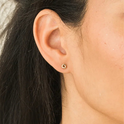 Kaur Eternal Knot Studs, crafted in 14K gold-filled splendor on model.