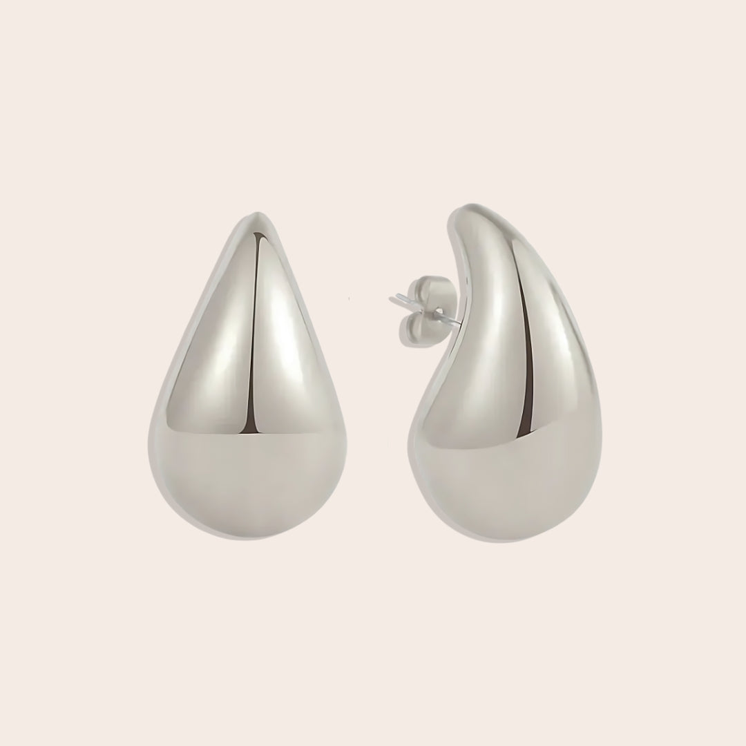 Large Tais Teardrop Earrings in silver. These eye-catching beauties, crafted from lightweight stainless steel and adorned with lustrous 18K gold plating.