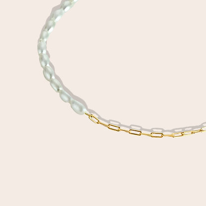 Close up of Mona Millet Pearl Choker in gold. This eye-catching piece features lustrous pearls paired with a delicate paperclip chain, all crafted from premium 925 sterling silver for lasting beauty and comfort.