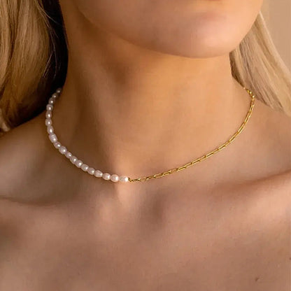 Mona Millet Pearl Choker in gold. This eye-catching piece features lustrous pearls paired with a delicate paperclip chain, all crafted from premium 925 sterling silver for lasting beauty and comfort.