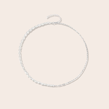 Mona Millet Pearl Choker in silver. This eye-catching piece features lustrous pearls paired with a delicate paperclip chain, all crafted from premium 925 sterling silver for lasting beauty and comfort.