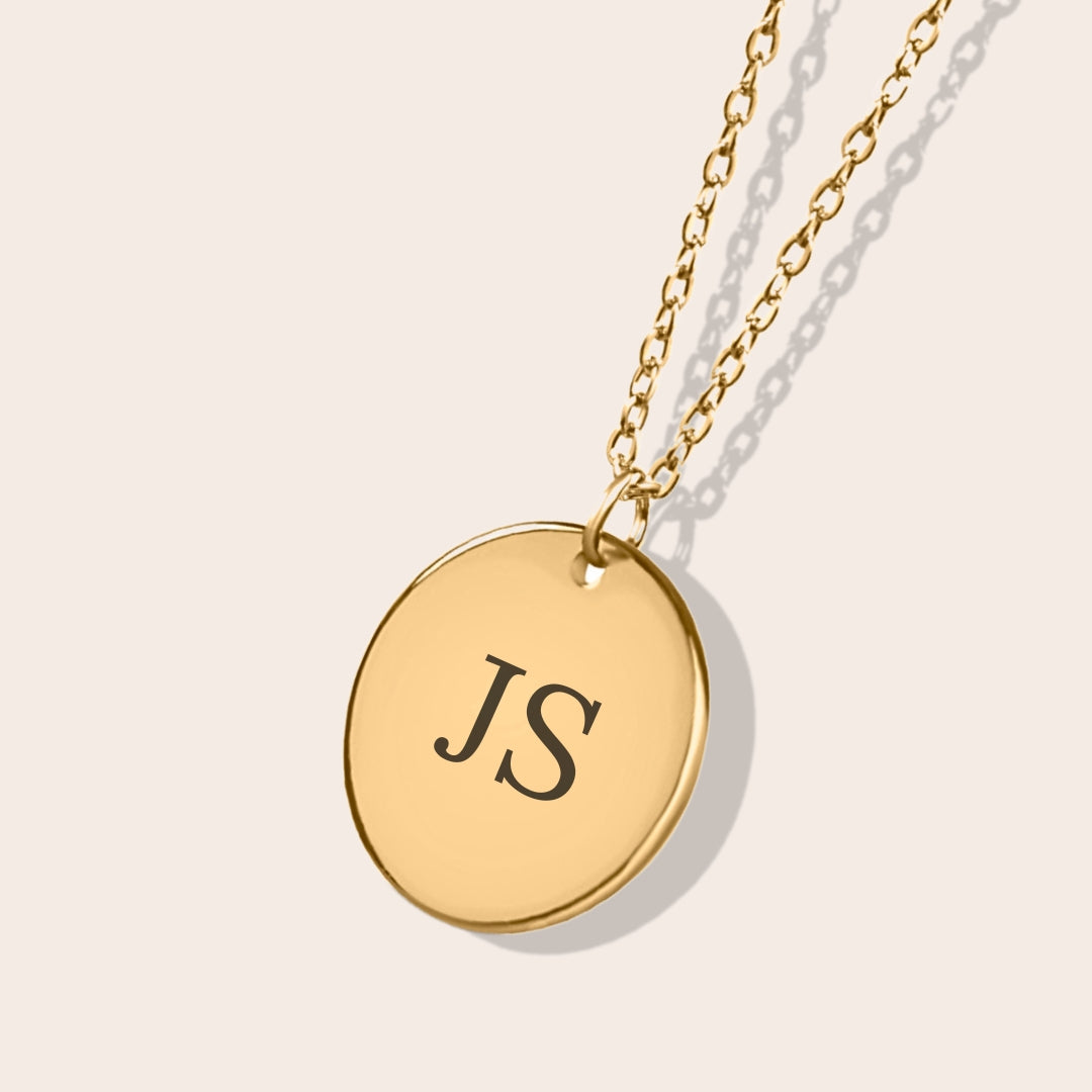 Close up of Initials Coin Necklace in gold. Laser engraving available on back side.