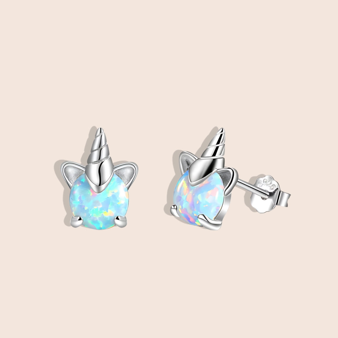 Opal Unicorn Stud Earrings, side view. Crafted from 925 sterling silver, plated with platinum, and adorned with shimmering white opals.