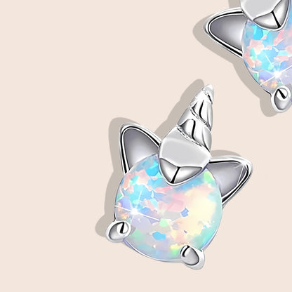 Opal Unicorn Stud Earrings, close up. Crafted from 925 sterling silver, plated with platinum, and adorned with shimmering white opals.