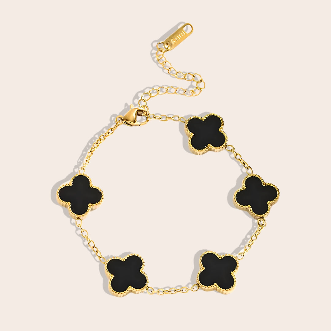 This charming piece in black features five delicate quatrefoil charms, crafted in stainless steel and lavishly plated in 18K gold.