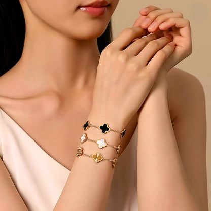 This charming piece on model features five delicate quatrefoil charms, crafted in stainless steel and lavishly plated in 18K gold 1.