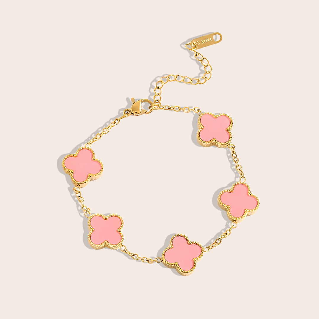 This charming piece in pink features five delicate quatrefoil charms, crafted in stainless steel and lavishly plated in 18K gold.