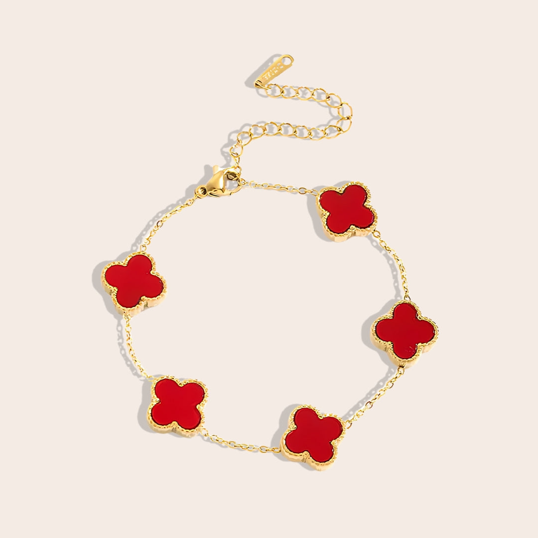 This charming piece in red 
features five delicate quatrefoil charms, crafted in stainless steel and lavishly plated in 18K gold.