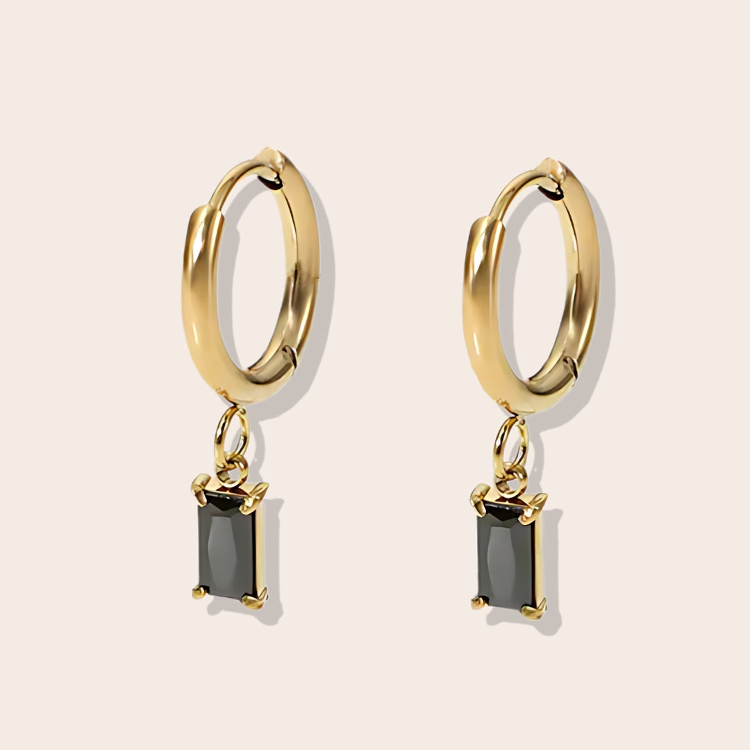 Rhea Rectangular Huggies in opal. Made from stainless steel and plated with 18k gold, these earrings are inlaid with sparkling cubic zirconia.