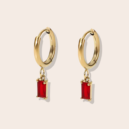 Rhea Rectangular Huggies in ruby. Made from stainless steel and plated with 18k gold, these earrings are inlaid with sparkling cubic zirconia.