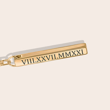 Close up of personalized Roman Date Keychain Gold.