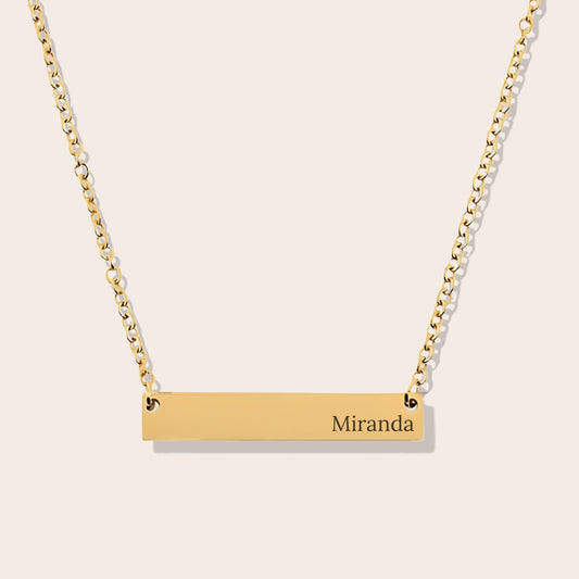 Customizable name necklace with front engraving and special message for back engraving. Gold, horizontal bar orientation.