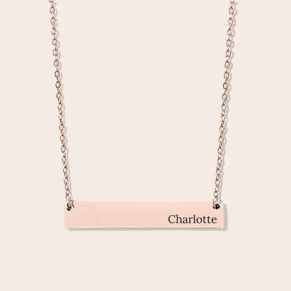 Customizable couples name necklace with front engraving and special message for back engraving. Rose gold, horizontal bar orientation.