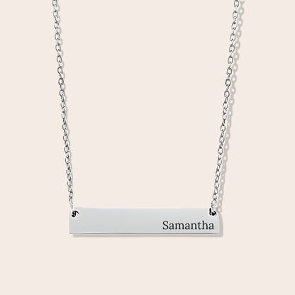 Customizable couples name necklace with front engraving and special message for back engraving. Silver, horizontal bar orientation.